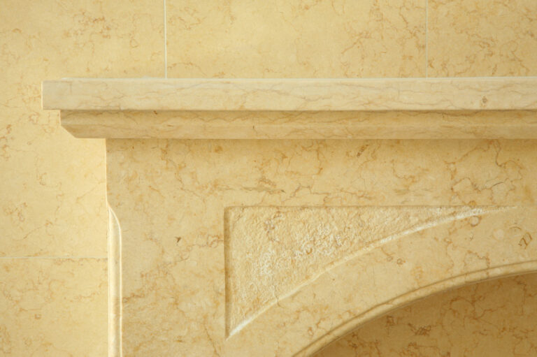 Detailed custom limestone installation on fireplace mantle - ADV Masonry