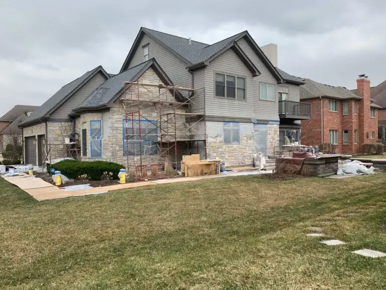 Residential masonry services Downers Grove with stone veneer restoration on home exterior