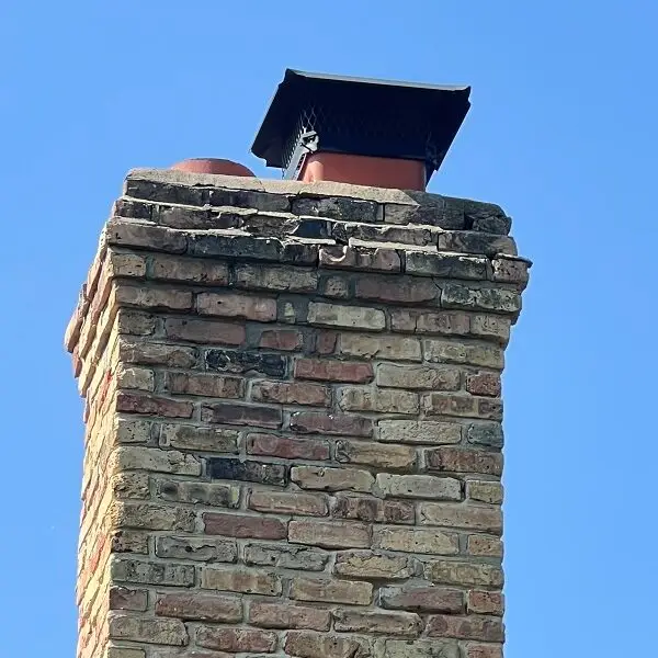 Chimney with deteriorated mortar joints, gaps, cracks, and falling material, needing chimney repair Near Naperville.