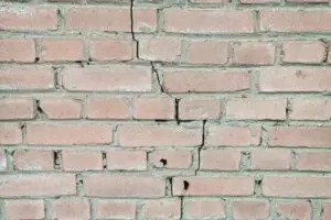 Masonry wall with cracked, chipping bricks and deteriorated joints, needing masonry repair Naperville area by ADV Masonry.