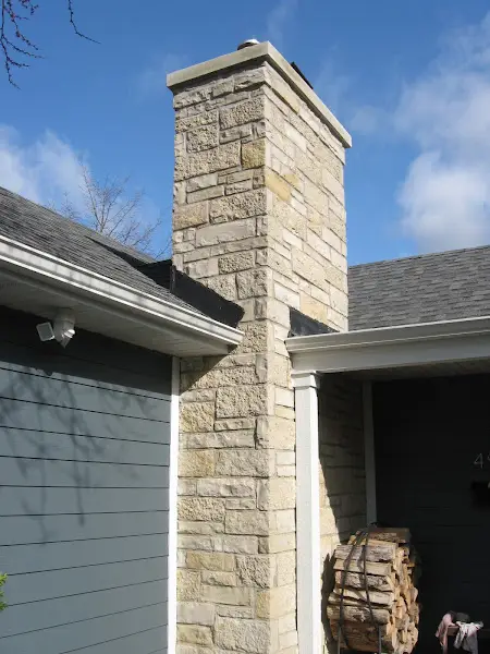 Restored stone chimney completed by ADV Masonry at a residential property in Naperville.