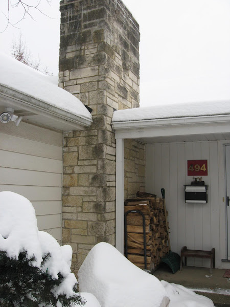 Stone chimney before masonry restoration by ADV Masonry at a Naperville home.